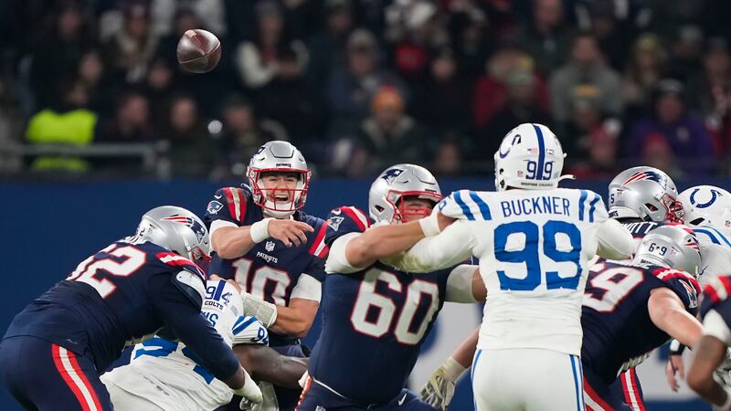 New England Patriots quarterback Mac Jones (10) passes under pressure in the second half of an...