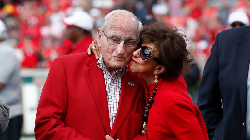 FILE - Former head Georgia football coach and athletic director Vince Dooley, left, gets a...