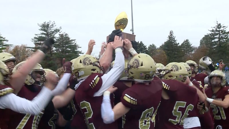 Thornton Academy lifts the gold ball following their victory over Portland