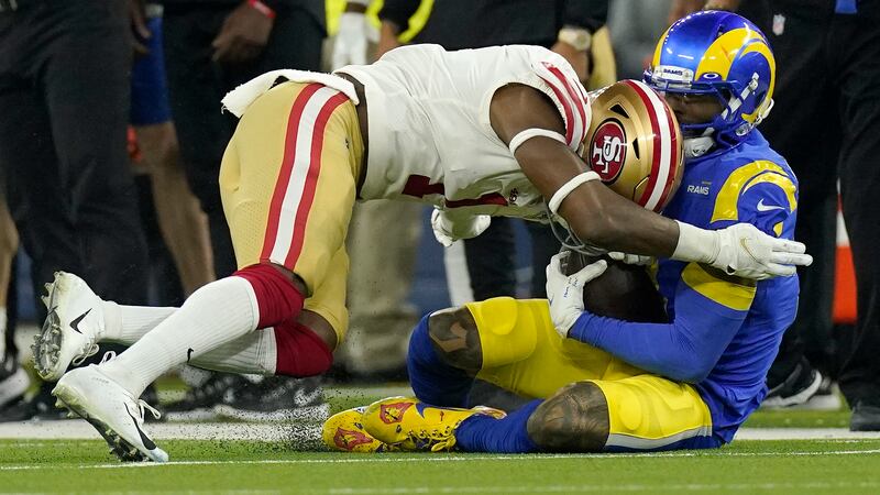 San Francisco 49ers' Jimmie Ward, left, is called for a penalty as he hits Los Angeles Rams'...