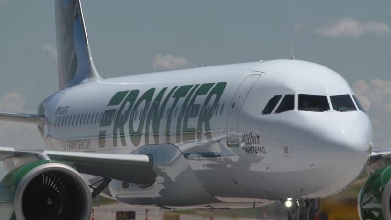 Frontier Airlines says a female passenger hit a flight attendant with an intercom phone as she...