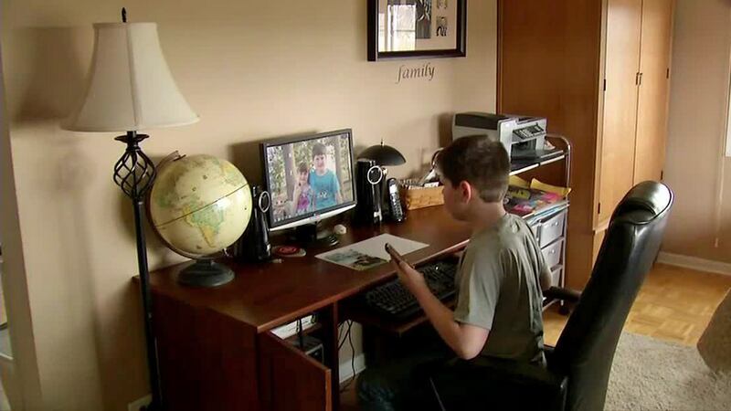 A child works at a computer at home for school during remote learning.
