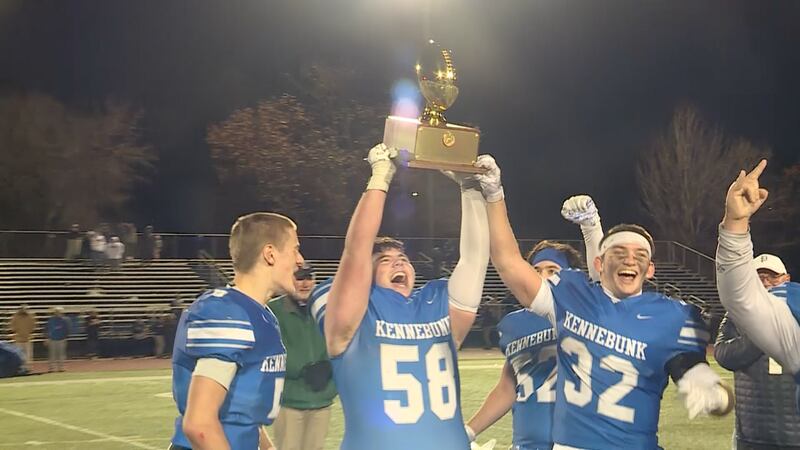 The Kennebunk Rams lift the gold ball following their win over Lawrence