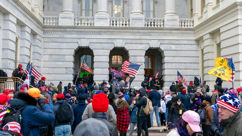 Supporters of President Donald Trump try to open a door of the U.S. Capitol on Wednesday, Jan....