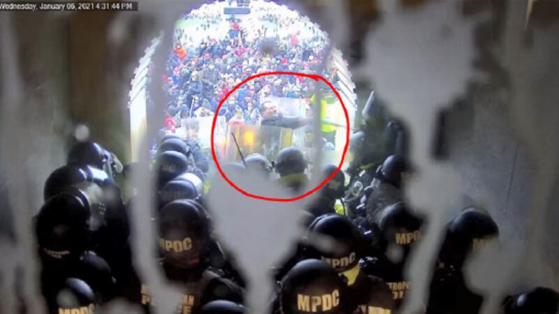 Maurer seen swinging pole or pipe at law enforcement officers on january 6, 2021 at U.S....